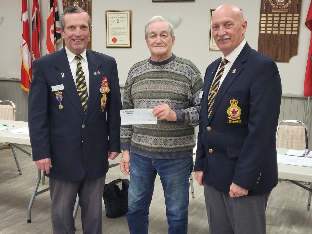 picture of Legion members Ken Thompson, Derek Moore and Foundation President, Bob Mason holding cheque